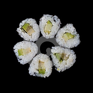 Sushi served on a black background with reflection.