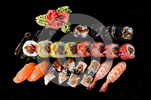 Sushi served on a black background with reflection.