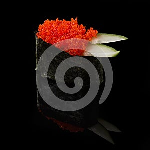 Sushi served on a black background with reflection.
