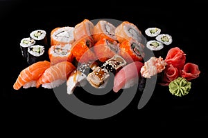 Sushi served on a black background with reflection.