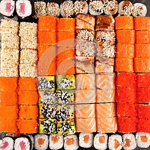 Sushi set compositionally located on a dark surface.