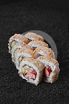 Sushi set from different rolls. Photo of food on a dark background.
