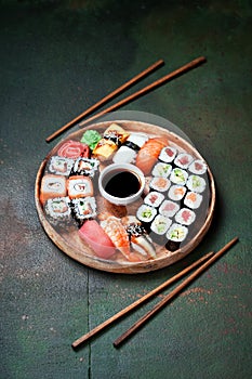 Sushi set nigiri and rolls served in round plate