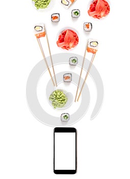 Sushi set rolls on white background chopsticks wasabi ginger phone delivery food concept