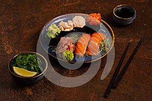 Sushi Set, Sashimi, Rolls Set on Table. Asian Cuisine. Healthy Food. Wakame Salat and Sushi Sticks