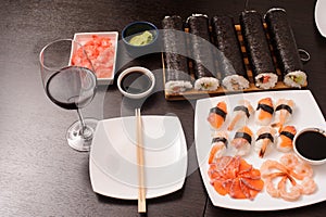 Set of sushi with empty plate and glass of wine