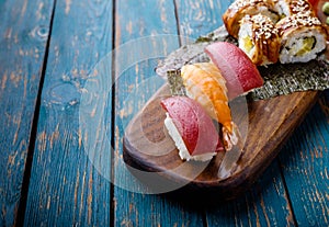 Sushi set on a wooden tray.