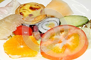 Sushi ,tomato,cake and fruit