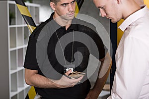 Suspected man talking with policeman photo