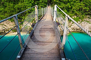 Suspended bridge above the emerald color Isonzo river, Kobarid Slovenia