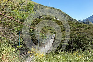 Suspended bridge hanging above the Santa Teresa River in green lush valley. Trek to Machu Picchu, Peru photo
