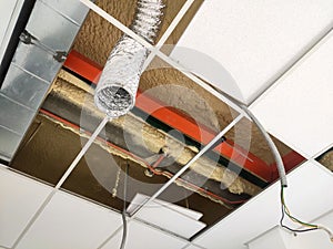 The suspended ceiling, electrical wiring, cabling and mechanical equipment under installation.