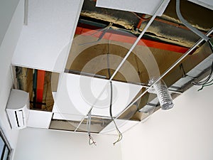 The suspended ceiling, electrical wiring, cabling and mechanical equipment under installation.