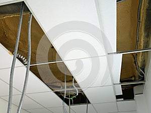 The suspended ceiling, electrical wiring, cabling and mechanical equipment under installation.