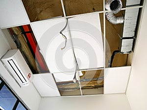 The suspended ceiling, electrical wiring, cabling and mechanical equipment under installation.