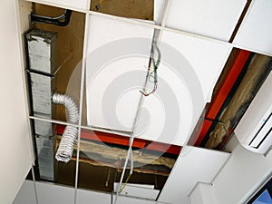 The suspended ceiling, electrical wiring, cabling and mechanical equipment under installation.