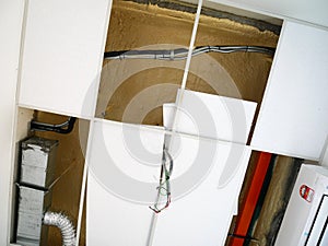 The suspended ceiling, electrical wiring, cabling and mechanical equipment under installation.