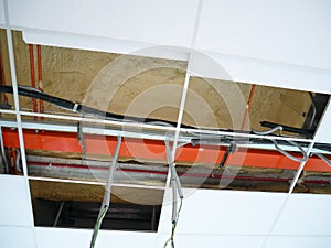 The suspended ceiling, electrical wiring, cabling and mechanical equipment under installation.