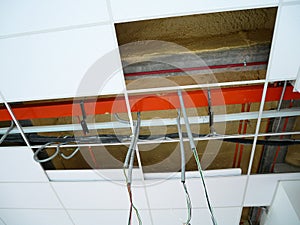 The suspended ceiling, electrical wiring, cabling and mechanical equipment under installation.