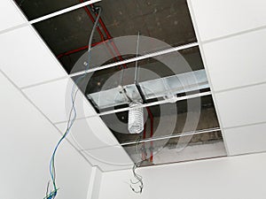 The suspended ceiling, electrical wiring, cabling and mechanical equipment under installation.