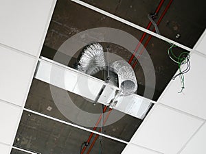 The suspended ceiling, electrical wiring, cabling and mechanical equipment under installation.