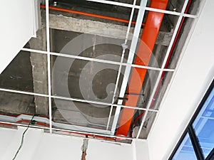 The suspended ceiling, electrical wiring, cabling and mechanical equipment under installation.