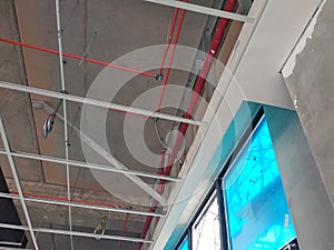 Suspended ceiling frame and board under construction at the construction site.