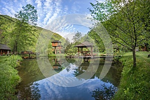 Suspended cottage near pond with small pontoon