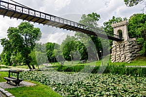 Suspended metallic bridge in Nicolae Romaescu park from Craiova in Dolj county, Romania, in a beautiful sunny spring day