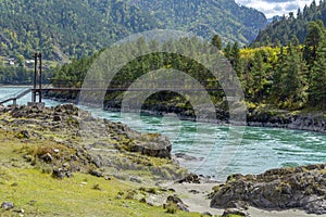 Suspended pedestrian bridge over the Katun river near the village of Elanda