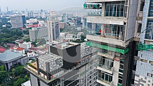 Suspended platform, construction cradle hanging on building. Installation and repair work. Building facades construction