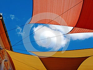 Suspended sun protection awning or tent cotton fabric stretched over street in old European town