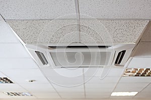 Suspended tile ceiling with big air-conditioner unit, office room photo