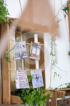 Suspended wood pallet and crates decorated with rope and wedding photos
