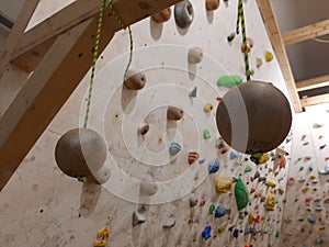 Suspension balls for climbing training hang on a climbing wall photo