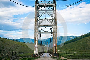 Suspension bridge across mountain river