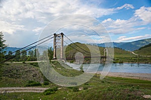 Suspension bridge across mountain river