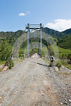 Suspension bridge across the river in the mountains