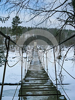 Suspension bridge across the river in the natural park Olenyi brooks in the Sverdlovsk region