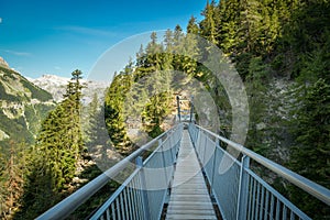 Suspension bridge on Bisse du Ro walking trail near Crans Montana in canton of Valais