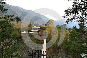 Suspension bridge and church on rocky coast Katun