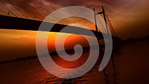 Suspension bridge known as the Vidyasagar Setu built on the river Ganges at dust at seen from Princep Ghat Kolkata India