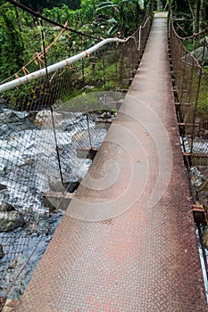 Suspension bridge over Caldera river near Boquete Panama , on Lost Waterfalls hiking trai