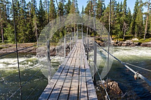 Suspension bridge over a part of Trollforsen rapid in Pite river in the Northern Sweden