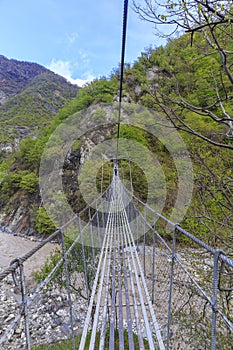 Suspension bridge over the river in the mountains