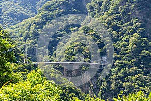 Suspension bridge over stream flowing between gorge in Taroko National Park in Hualien of Taiwan