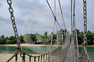 Suspension bridge leading from Palawan Beach in Sentosa Island, Singapore, to `the Southernmost point of Continental Asia` photo