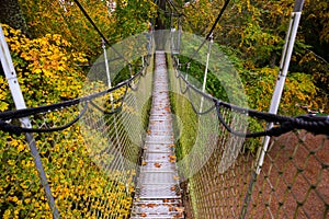 Suspension bridge in the Park. Landscape View of the long steel suspension bridge over the forest. Egeskov Castle, Denmark