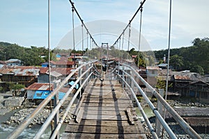 Suspension bridge in the small river village of Bukit Lawang