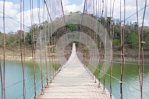 suspension bridge stretches through the middle of lake Kaeng Krachan tourist area in Thailand. this image for nature, landscape